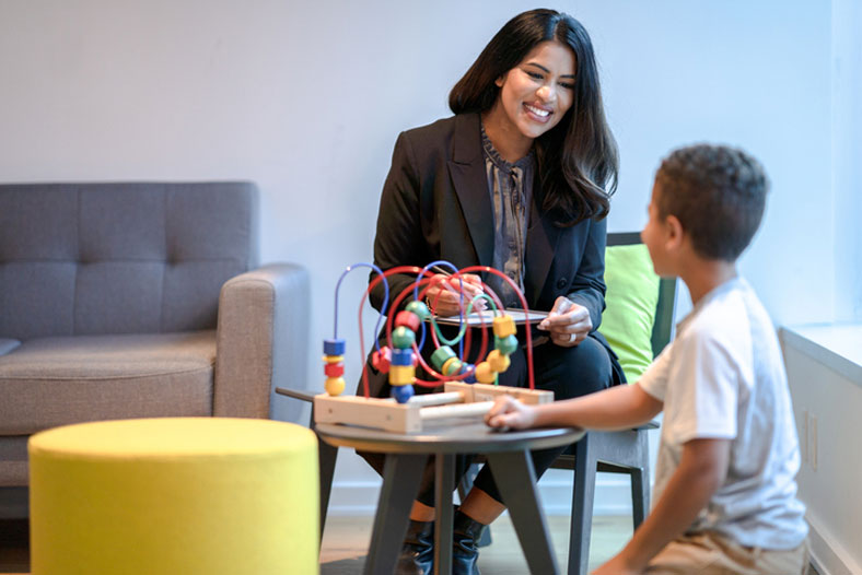 social worker playing and talking with boy