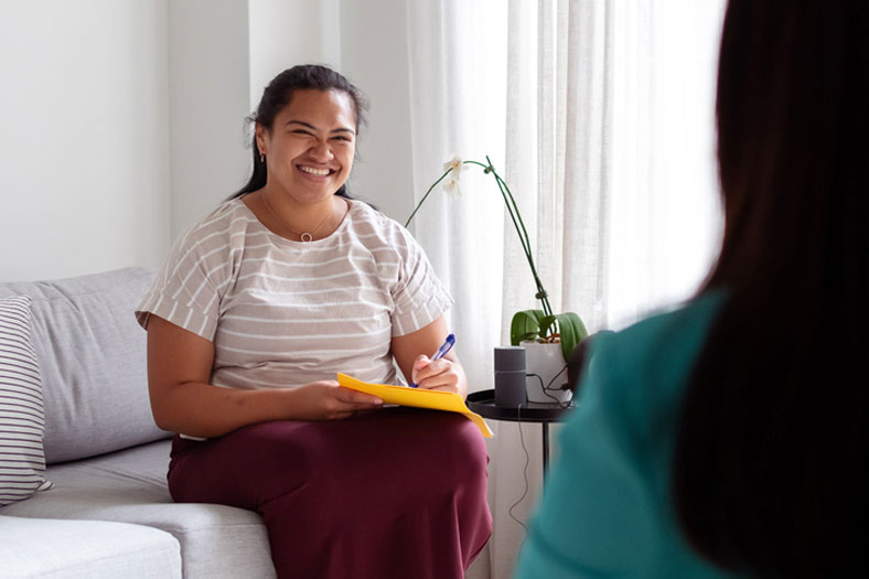 young lady talking with social worker in her office