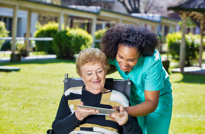 aging client on tablet with social worker