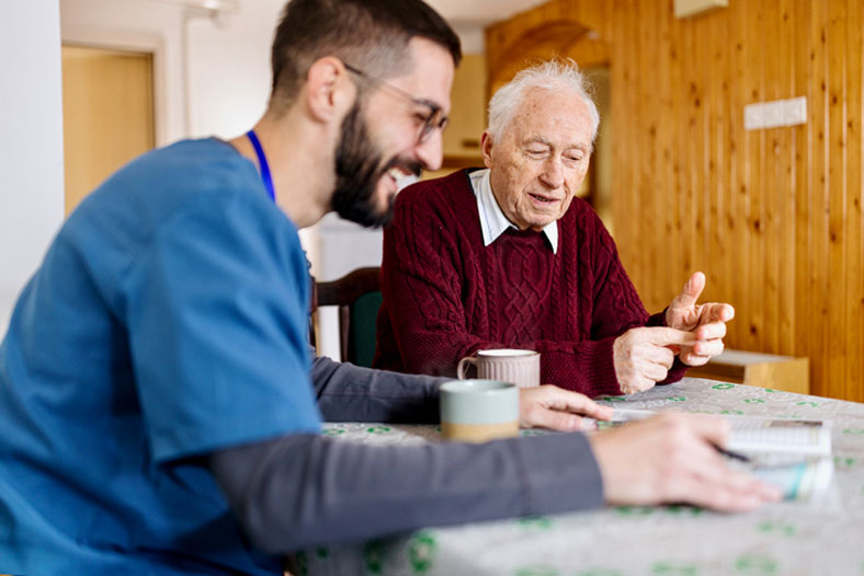 helping older client over coffee